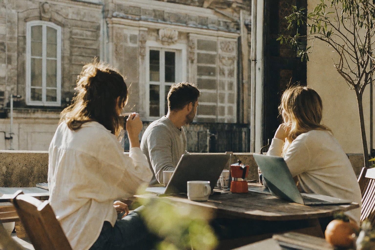 The team on a coffee break on a terrace